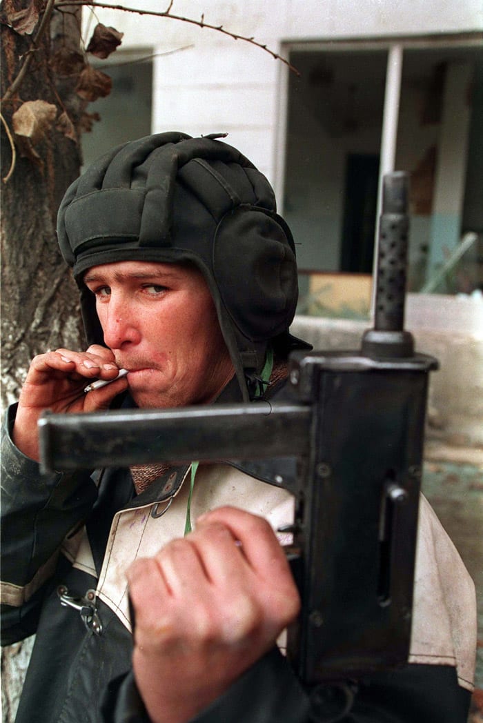 A Chechen fighter holds up his home-made gun during the battle for Grozny, January 1995, during the rebellion against the Russian Federation
