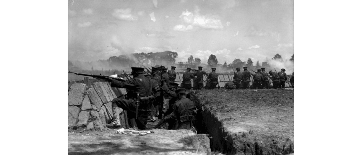 Federal troops fire from a trench, Mexican revolution. 1914