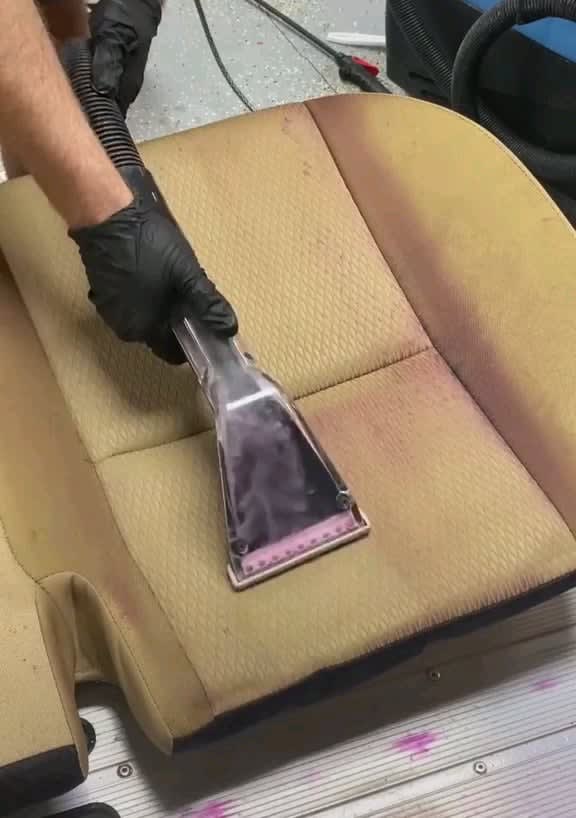 Deep cleaning a stained car seat.