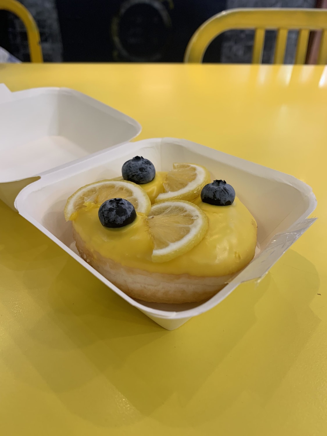 [I ate] a beautiful and super yummy lemon curd donut topped with blueberries and lemon chocolate