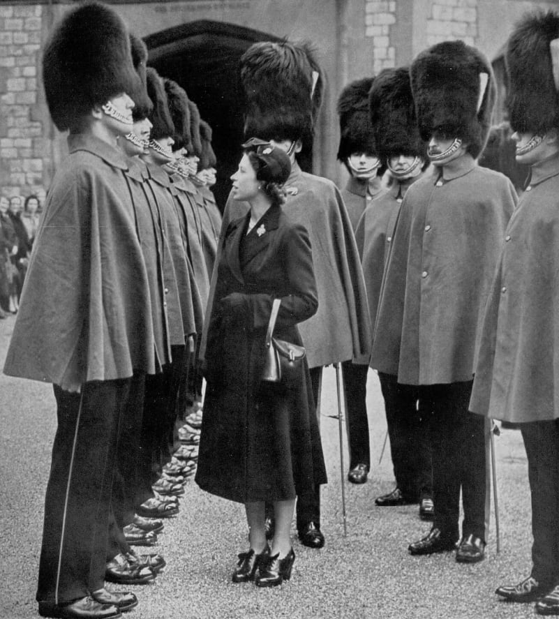 Queen Elizabeth II inspects soldiers of the Grenadier Guards Regiment at Windsor Castle during her 26th birthday (1952)