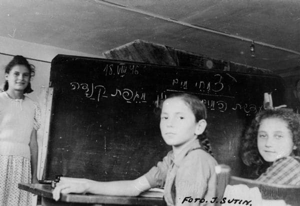 Child Holocaust survivors learning Hebrew at a Displaced Persons camp in Germany, 1946. Many survivors, as well as other war refugees, spent months or years in DP camps after the war, waiting to find a permanent home.