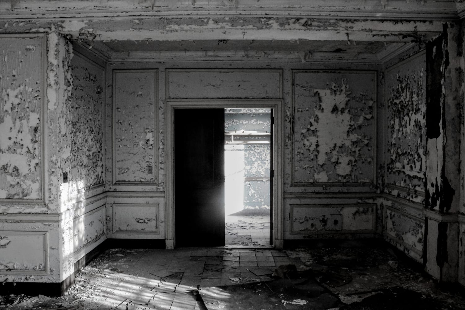 A doorway in decay in an abandoned mental hospital