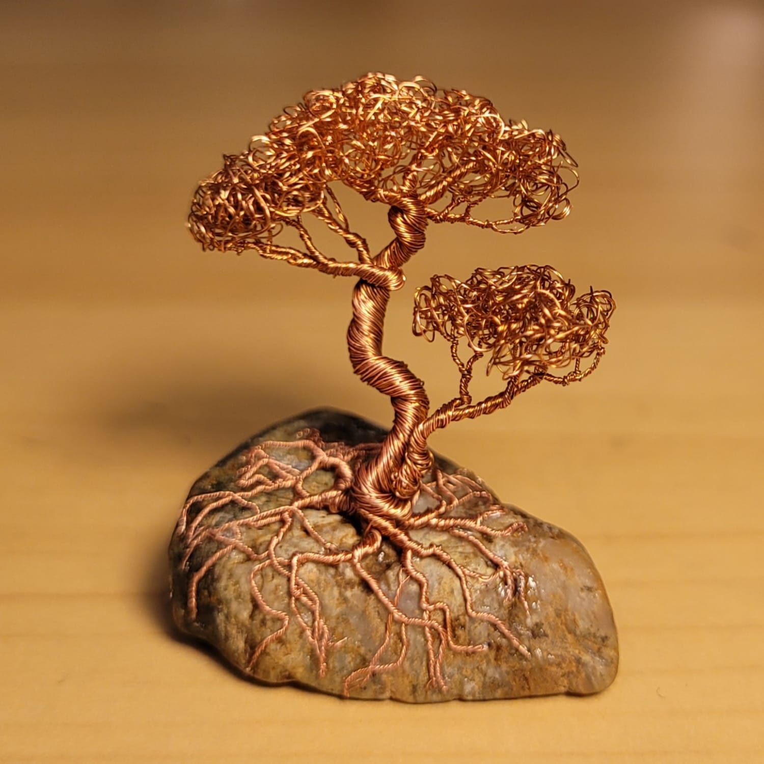 I made this tiny bonsai tree out of copper wire from an old USB cable