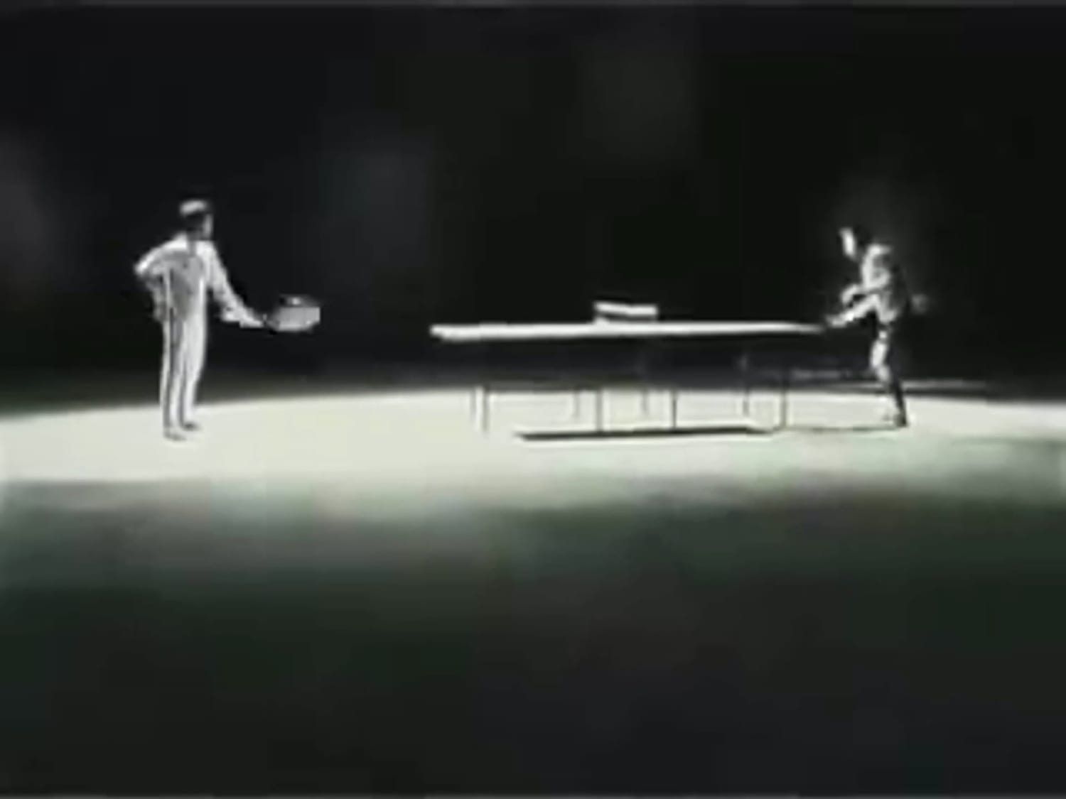Bruce Lee playing ping-pong with nunchucks.