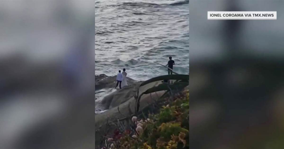 Heart-stopping video shows bride and groom swept out to sea while taking photos