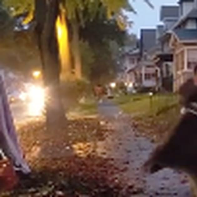 Scared trick-or-treater clocks giant inflatable baby in the face