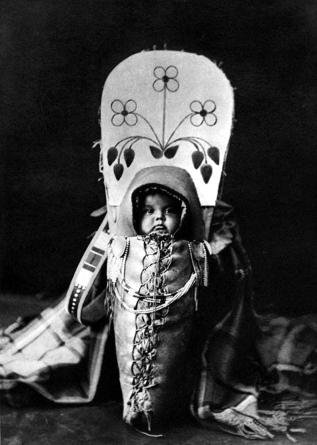Nez Perce baby in a traditional cradleboard, photographed by Edward Curtis, 1911