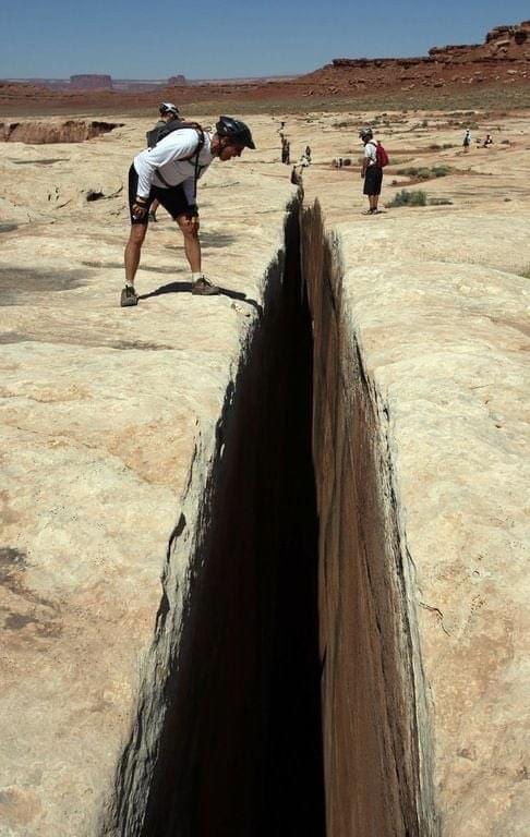The “Black Crack” along Utah’s White Rim Trail, a natural fissure in the rock a few feet wide and deep enough to kill you