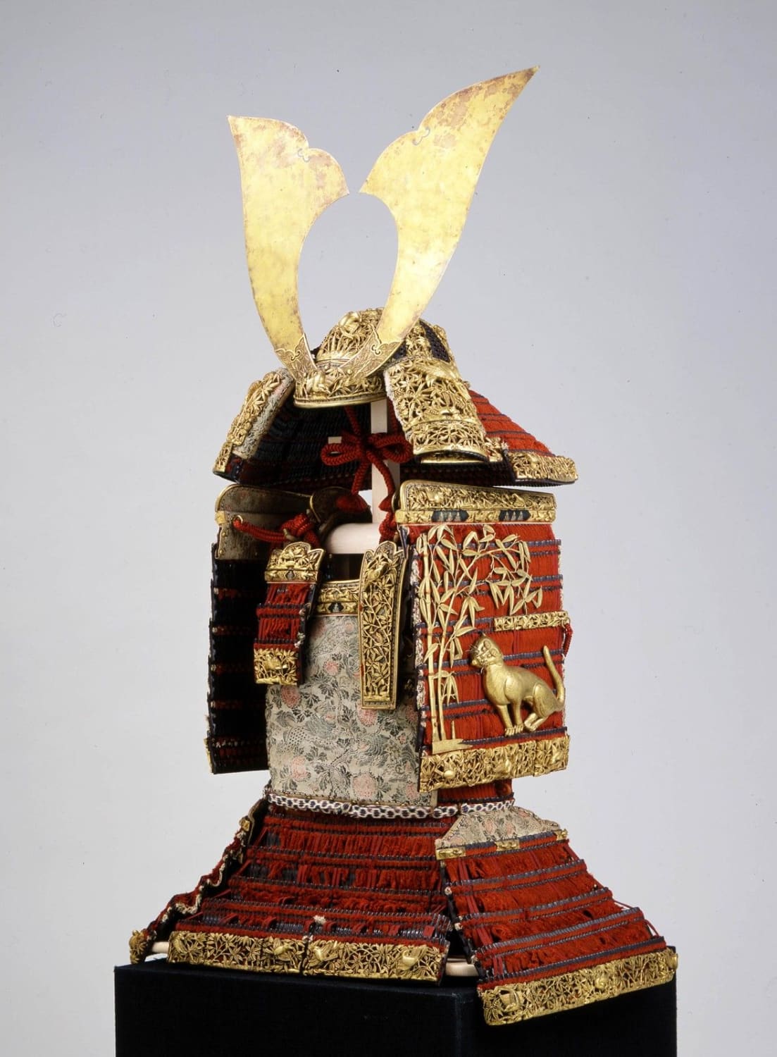 Armour laced with red threads with bamboo, tiger and sparrow motif, dedicated by Minamoto no Yoshitsune, one of Japan greatest samurai, to the Kasuga Taisha Shrine in Nara. Kamakura period, 12th century CE. The Armour is registered as a national treasure in Japan
