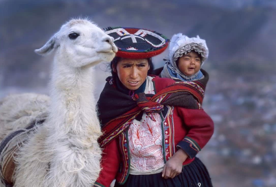 Woman from South America with child and llama (love the wee one's smile). (Image - Jim Zuckerman).