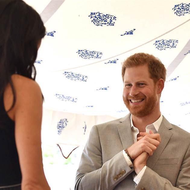 Watch Prince Harry fix Duchess Meghan's hair on a windy day in London