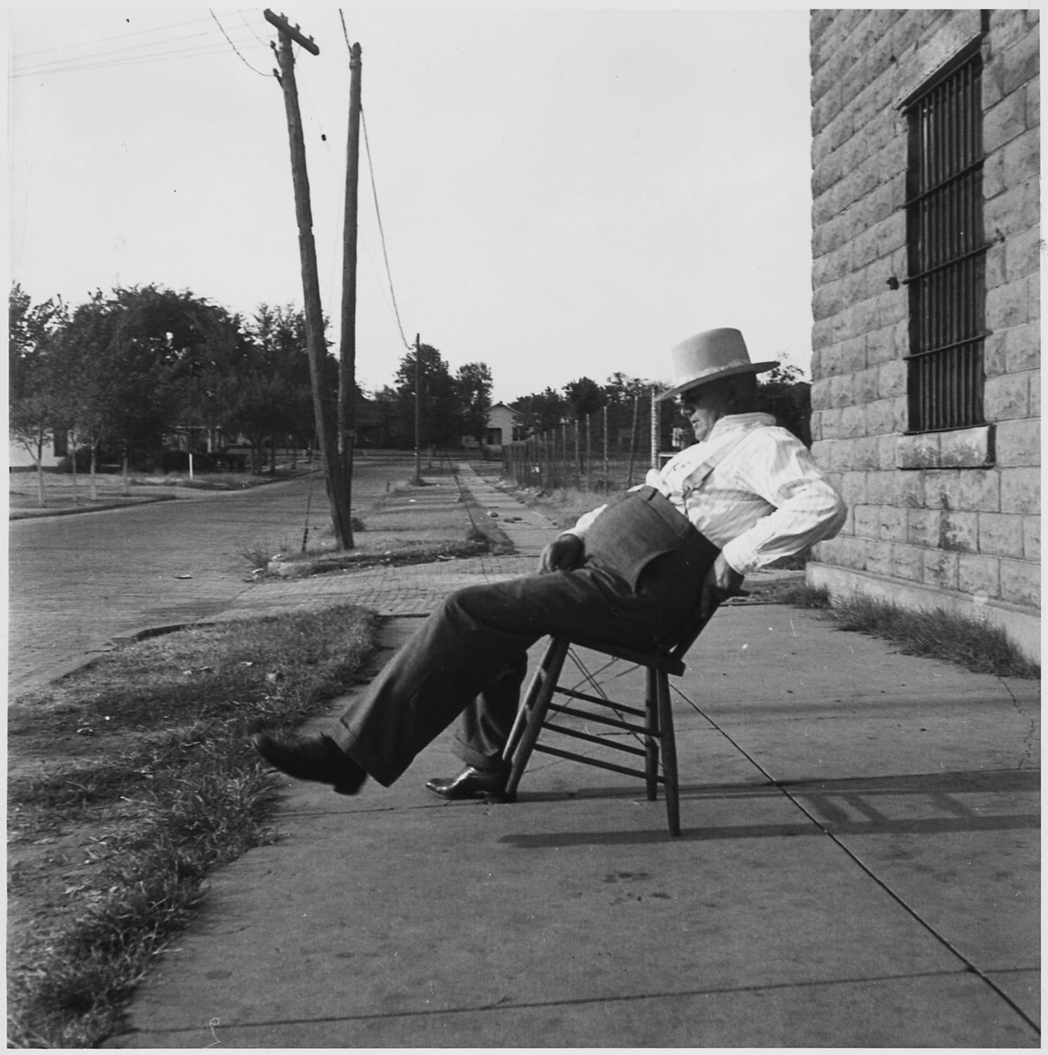 Sheriff of McAlester, Oklahoma, sitting in front of the jail, August 1936