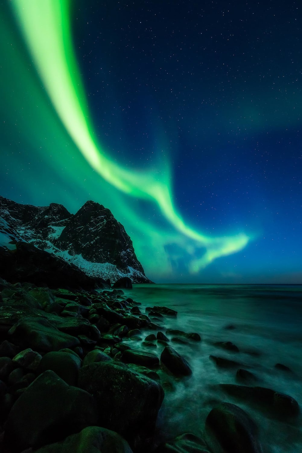 Green flames on the blue vernal night sky, and grumbled pieces of the mighty mountains, pounded and shaped by the endless great open ocean waves. Lofoten, Norway 04/2018 @mpxmark