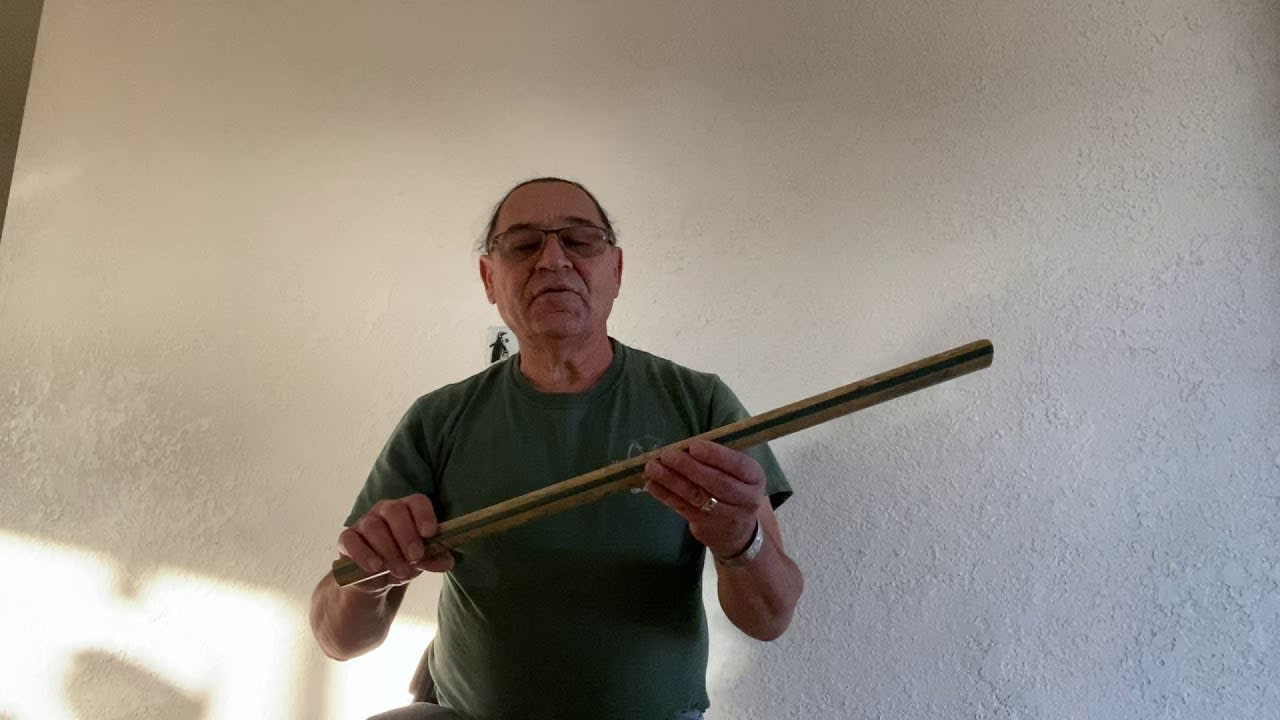 A guy reviews and plays Anasazi flute. A musical instrument of extinct Anasazi people.
