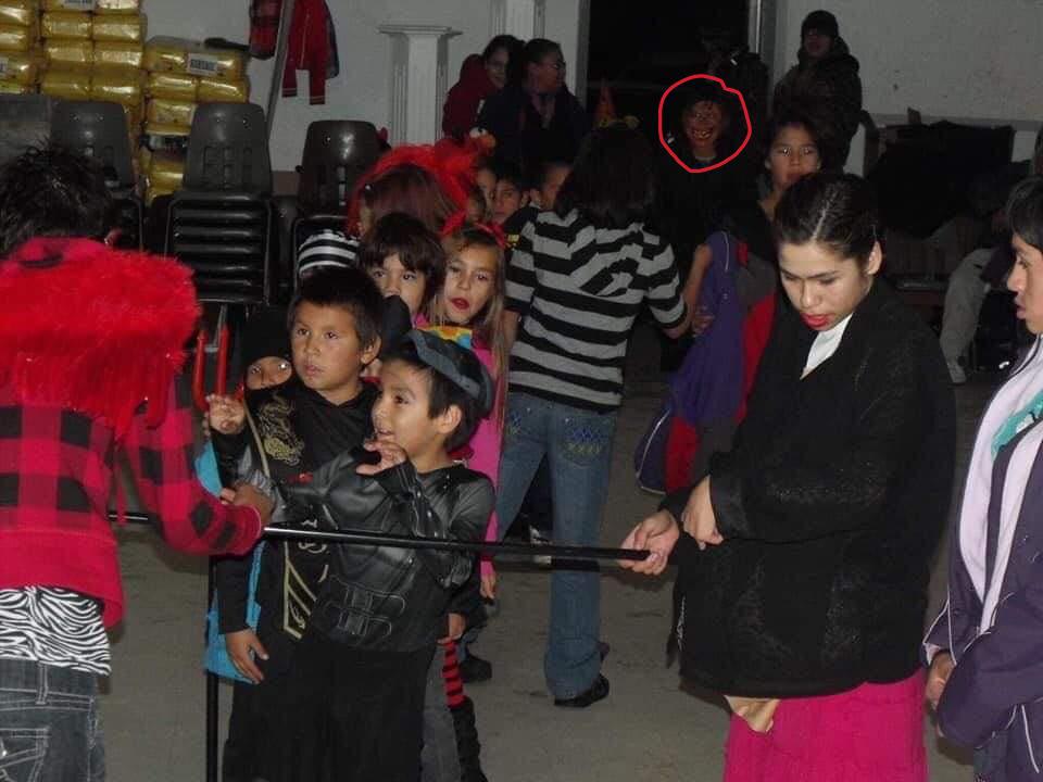 This photo was taken 10 years ago and was posted on facebook from one my family members.I was the one that discovered the weird face.Just zoom in on the red colored circle.now bare in mind my uncle doesn't know shit about Photoshop.And this is the original photo.But it could just be a camera glitch.