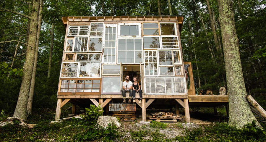 Artist couple built a cabin made of recycled windows in the West Virginia mountains for $500 (Video)