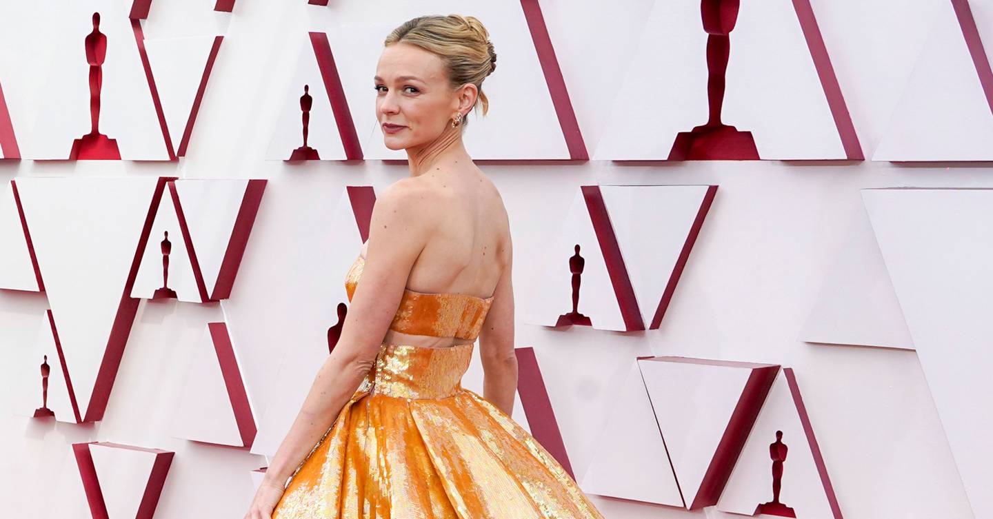 Carey Mulligan is a vision in gold Valentino Haute Couture as she arrives at the Oscars with her musician husband