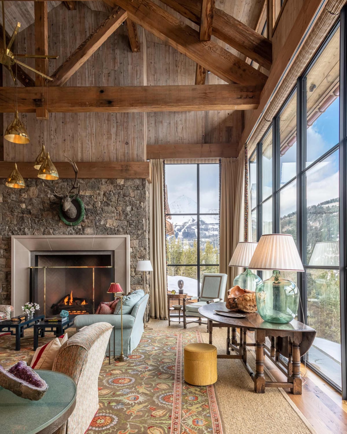 Tall living room with mountain views in a ski chalet at Big Sky, Montana