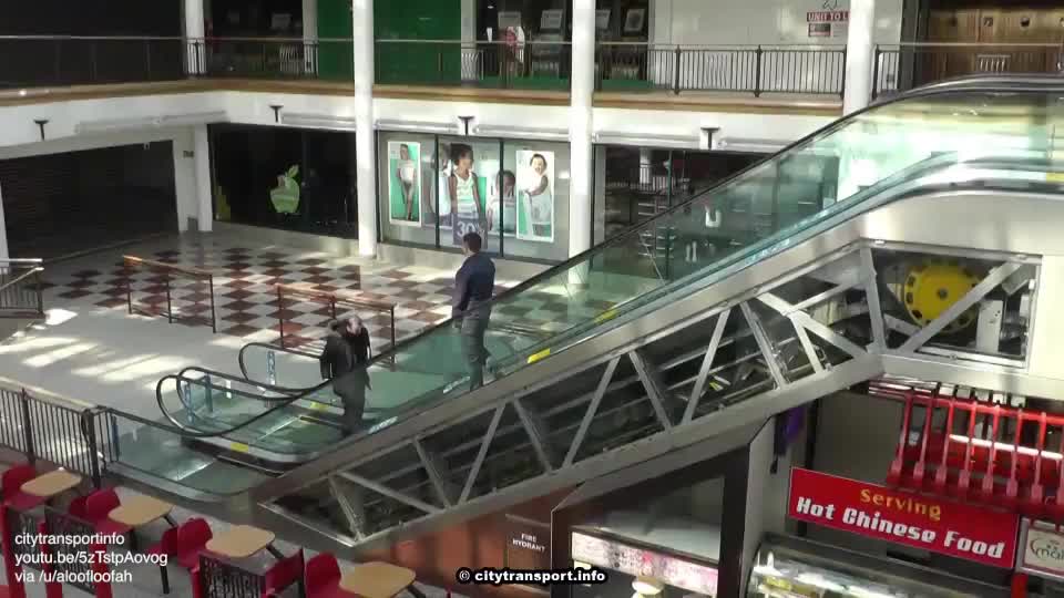 Escalator with a glass side so you can see inside