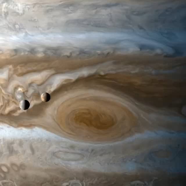Timelapse of Europa and Io orbiting Jupiter captured by the Cassini probe