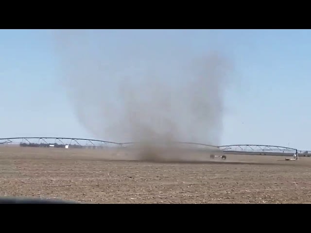 Dust Devil Swirls Across the Ground in the Distance - 1121785