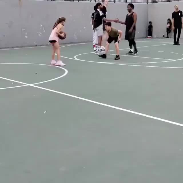 Challenging the only girl on the basketball court.