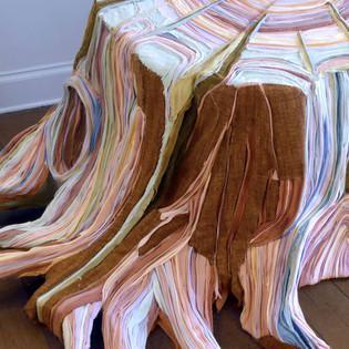 Artist creates layered tree stumps out of father's clothing after he passes away