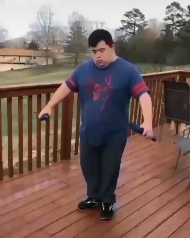 A guy with down syndrome using nun chucks like Bruce Lee