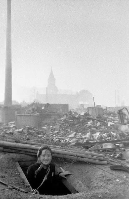 A survivor of the Nagasaki Atomic Bombing manages a grin. 10 August 1945, photo taken by Yōsuke Yamahata.