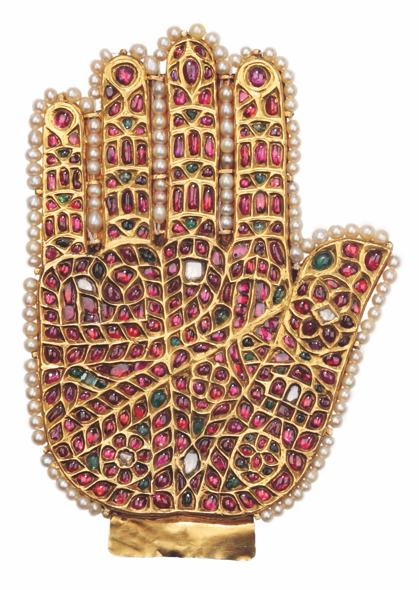 One of the two ‘Hands of Fatimah’ now in the Khalili Collection of Islamic Art. Made in India in the late 18th or early 19th century. Gold on a lac core, set with foiled rubies, diamonds and emeralds in gold kundan and with strings of small pearls