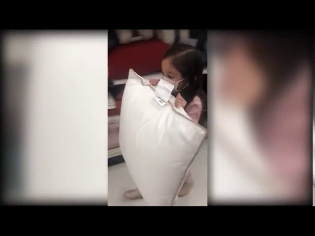 Five-Year-Old Girl Cleans Up Pillow Aisle In Retail Store - 1161052