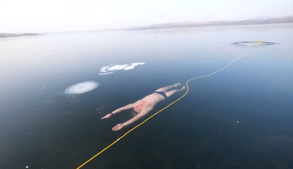Freediver Swims Directly Under the Ice of Frozen Lake