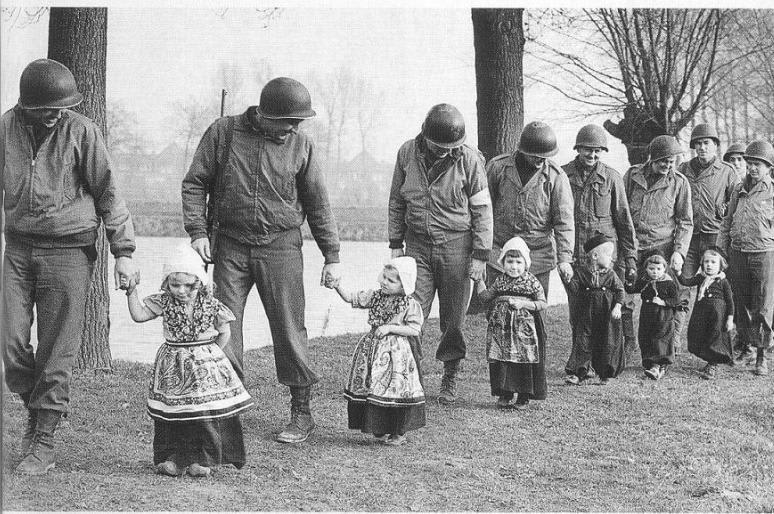 American soldiers take Dutch children for a dance. World War II, 1944,