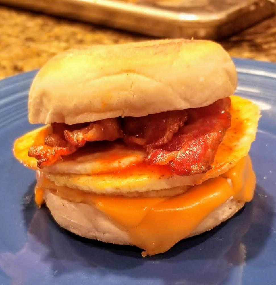 Bacon egg and cheese I made on homemade sourdough English muffin, topped with homemade Scotch bonnet hot sauce