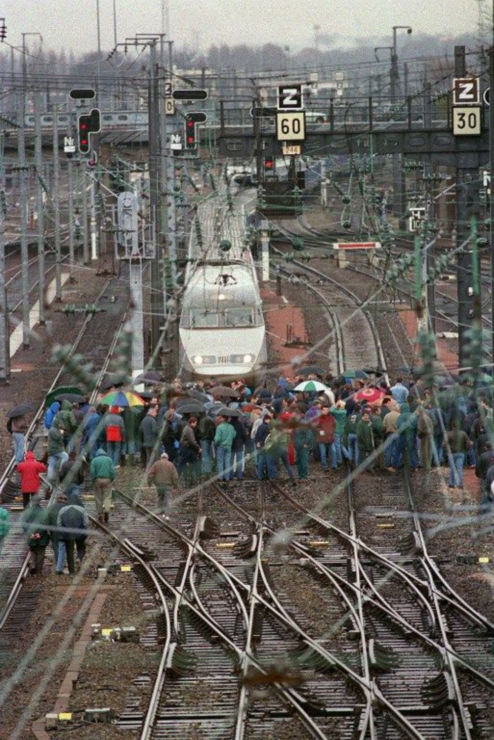 Striking French railway workers block a TGV train from entering Rennes station. Nov 27, 1995.