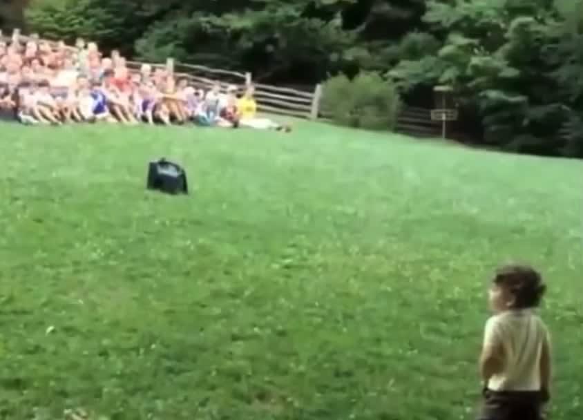 Little boy thinks the crowd gathered at the park for him.