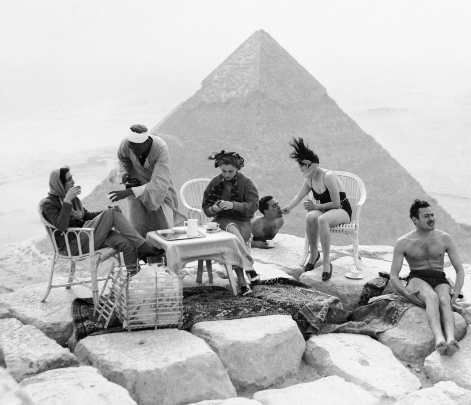 Group of tourists sunbathing and drinking tea on top of the Great Pyramid in 1938
