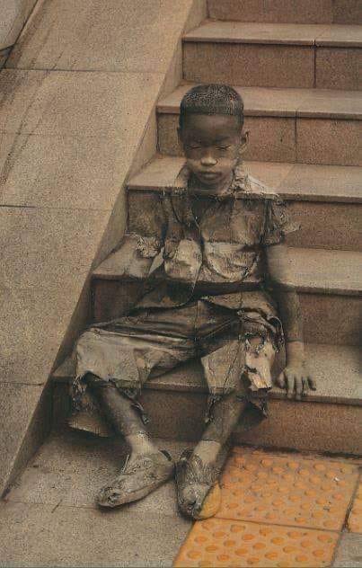 'The Invisibility Of Poverty' is street art by Kevin Lee. The child is depicted sitting on steps, being stepped on & stepped over to illustrate how invisible the poor living among us can be.