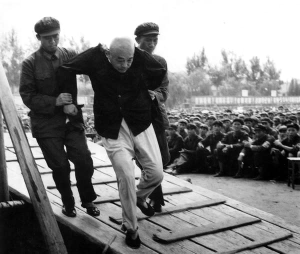 Chinese Marshal Peng Dehuai, who had commanded the Chinese Army during Korean War and was purged after his criticism of Mao Zedong's policies during the Great Leap Forward, is being dragged by Red Guards to a public humiliation ceremony in Beijing, during the Cultural Revolution - 1960s