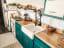Farmstyle teal blue kitchen in 35-foot International 3800 school bus turned skoolie, Florida ]