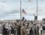Inmates waving a home-made American flag greet U.S. Seventh Army troops upon their arrival at the Allach concentration camp. April 30, 1945. [Colorization]