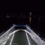 Stingray passing under a clear boat at night