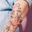 Soft Color Flower Arm Tattoo