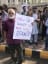 A sign held by an old man at a women's march in Karachi