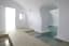 The pure white interior of a swim-in, swim-out suite in Santorini