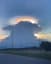 What appears to be a Cumulonimbus cloud crowned by a Lenticular Cloud, filmed in Japan.