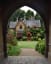 Victorian Gothic cottage beyond the arch of the gatehouse in Holly Village, Highgate, North London, UK.