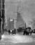 A snowy day in old Rotterdam, with the windmill "De Hoop" visible in the background, the Netherlands (1913)