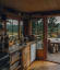 Rustic cabin kitchen opening up to a deck overlooking the wilderness of Veldre Almenning, Innlandet, Norway